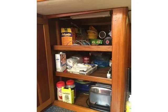Slide: The Image of Wooden kitchen cabinet with shelves storing various food items and appliances, Gorbon Custom 66, 1997. - 143