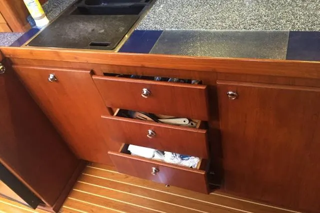 Slide: The Image of Wooden kitchen cabinetry with open drawers in a 1997 Gorbon Custom 66 yacht. - 145