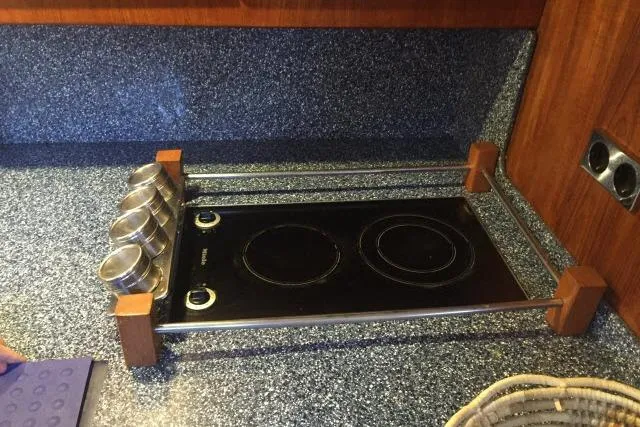 Slide: The Image of Electric stovetop on Gorbon Custom 66 yacht, 1997 model, with spice containers and wooden accents. - 146