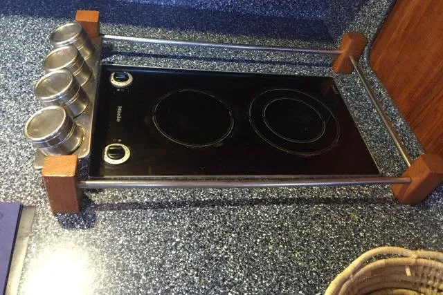 Slide: The Image of Ceramic cooktop with spice jars, Gorbon Custom 66, 1997 model, on speckled countertop. - 147