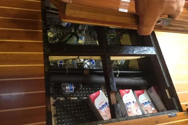 Slide: The Image of Hidden compartment in 1997 Gorbon Custom 66 yacht with bottles and cartons. - 150