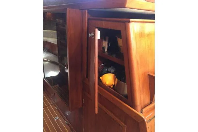 Slide: The Image of Wooden interior of 1997 Gorbon Custom 66 yacht, featuring storage cabinet and polished finish. - 152