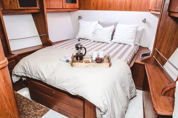 Slide: The Image of Cozy cabin bedroom in 1997 Gorbon Custom 66 yacht with breakfast tray on bed. - 154