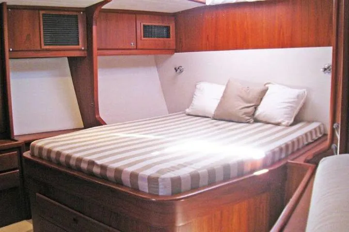 Slide: The Image of Luxurious cabin interior of 1997 Gorbon Custom 66 yacht with striped bedding. - 155