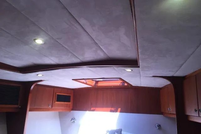 Slide: The Image of Luxurious interior of 1997 Gorbon Custom 66 yacht with wood paneling and recessed lighting. - 156