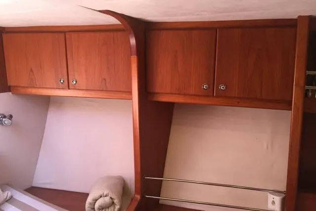 Slide: The Image of Interior of 1997 Gorbon Custom 66 yacht with wooden cabinets and cozy bedding. - 157