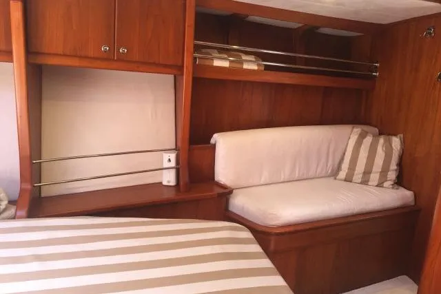 Slide: The Image of Cozy cabin interior of 1997 Gorbon Custom 66 yacht with striped bedding and cushions. - 158
