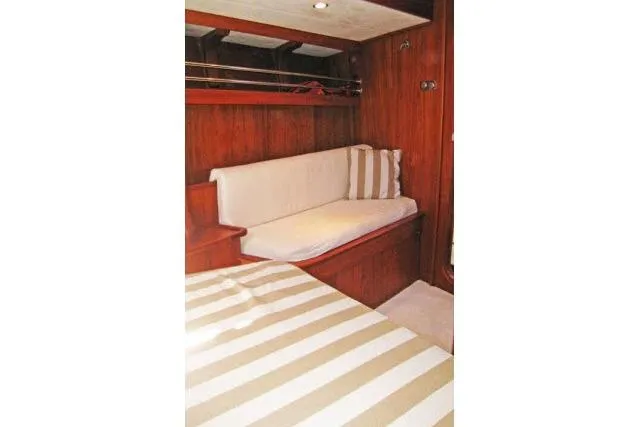 Slide: The Image of Interior of 1997 Gorbon Custom 66 yacht with wooden paneling and striped upholstery. - 159