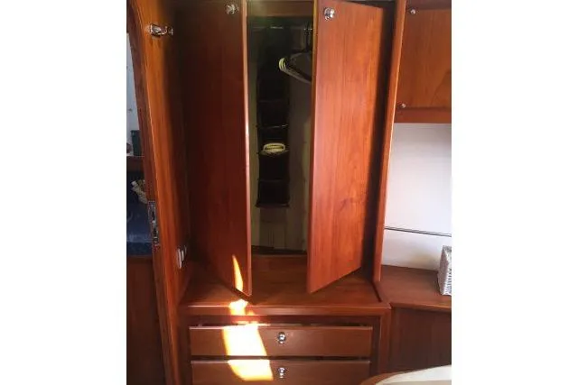 Slide: The Image of Wooden wardrobe with open doors and drawers in a 1997 Gorbon Custom 66 yacht. - 163
