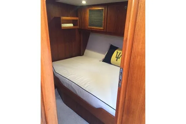 Slide: The Image of Cozy cabin interior of 1997 Gorbon Custom 66 yacht with wooden finish and comfortable bedding. - 166