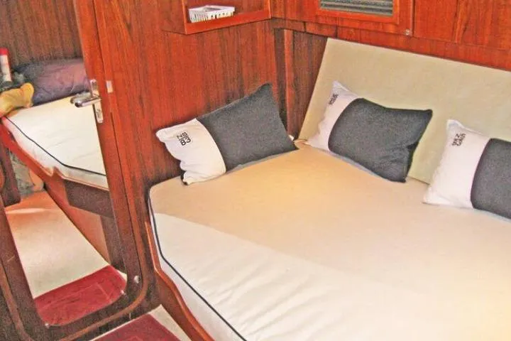Slide: The Image of Cozy cabin interior of 1997 Gorbon Custom 66 yacht with wooden finish and cushions. - 167