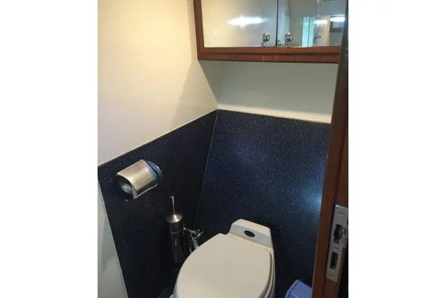 Slide: The Image of Compact bathroom in a 1997 Gorbon Custom 66 yacht, featuring modern fixtures and storage. - 169