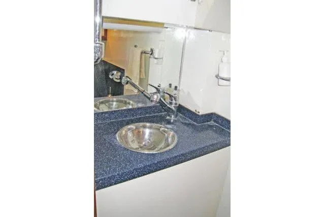 Slide: The Image of Compact bathroom sink area in a 1997 Gorbon Custom 66 yacht. - 170