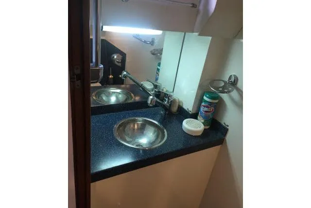Slide: The Image of Compact bathroom sink area in a 1997 Gorbon Custom 66 yacht, featuring a stainless steel basin. - 171