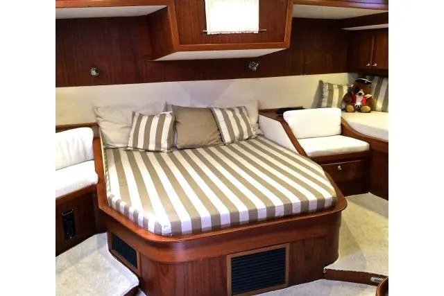 Slide: The Image of Luxurious cabin interior of 1997 Gorbon Custom 66 yacht with striped bedding. - 172
