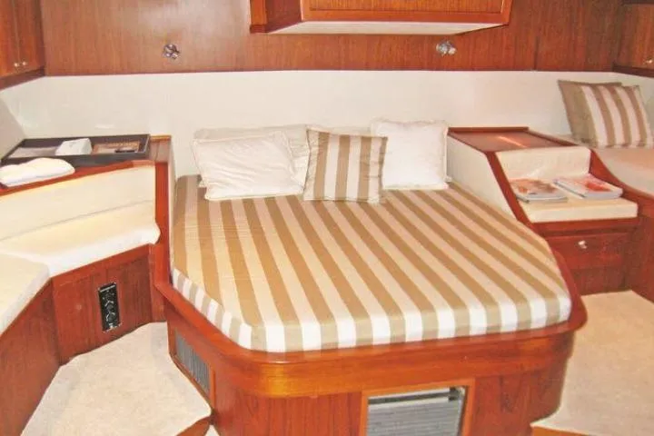 Slide: The Image of Luxurious cabin interior of 1997 Gorbon Custom 66 yacht with striped bedding. - 173