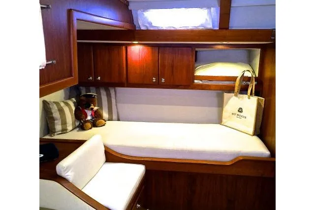 Slide: The Image of Luxurious cabin interior of 1997 Gorbon Custom 66 yacht with cozy bedding and wooden cabinetry. - 175