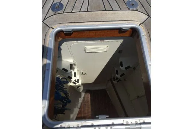 Slide: The Image of Open hatch on 1997 Gorbon Custom 66 yacht deck, revealing interior storage space. - 180