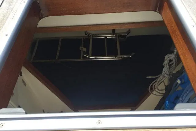 Slide: The Image of Hatch view inside 1997 Gorbon Custom 66 boat, featuring ladder and ropes. - 181