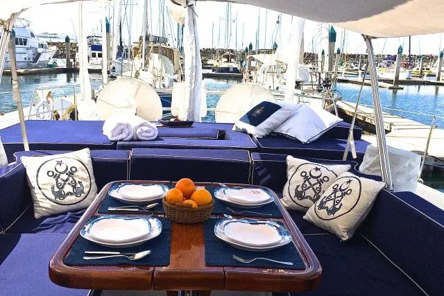 Slide: The Image of Luxurious Gorbon Custom 66 yacht deck with dining setup, 1997 model, docked at marina. - 191