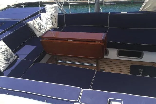 Slide: The Image of Luxurious seating area on a 1997 Gorbon Custom 66 yacht with blue cushions. - 193