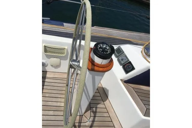 Slide: The Image of Steering wheel and compass on 1997 Gorbon Custom 66 yacht deck. - 198