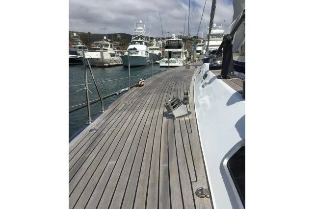 Slide: The Image of Deck view of a 1997 Gorbon Custom 66 yacht docked at a marina. - 208