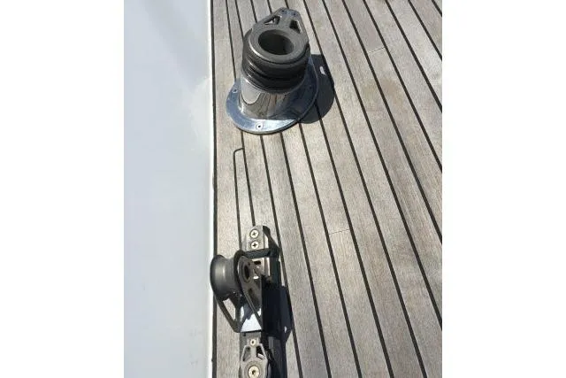 Slide: The Image of Deck fittings on a 1997 Gorbon Custom 66 yacht, featuring wood paneling and metal hardware. - 210
