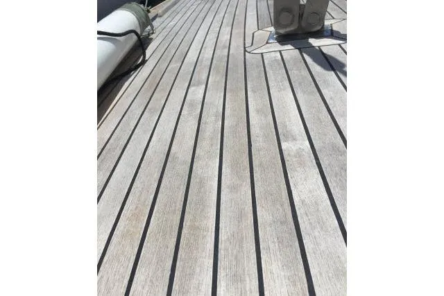 Slide: The Image of Teak deck of 1997 Gorbon Custom 66 yacht, showcasing sleek wooden planks. - 212