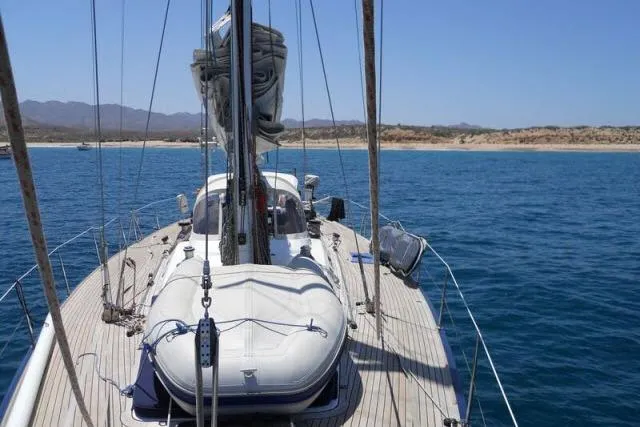 Slide: The Image of Sailing yacht Gorbon Custom 66, 1997 model, anchored near a scenic coastline. - 218