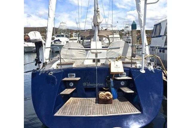 Slide: The Image of Blue Gorbon Custom 66 yacht, 1997 model, docked at marina with wooden deck. - 222
