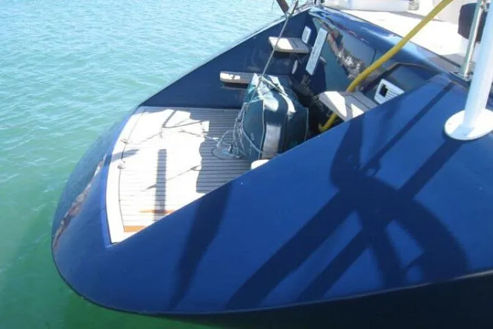Slide: The Image of Gorbon Custom 66 yacht, 1997 model, featuring a sleek blue deck on calm waters. - 223
