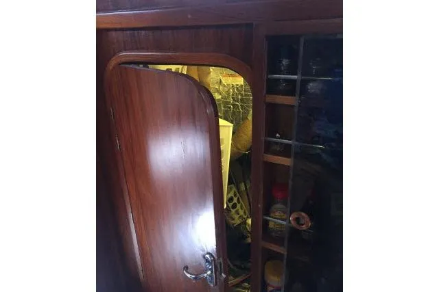 Slide: The Image of Wooden interior of 1997 Gorbon Custom 66 yacht, featuring a partially open cabinet door. - 224