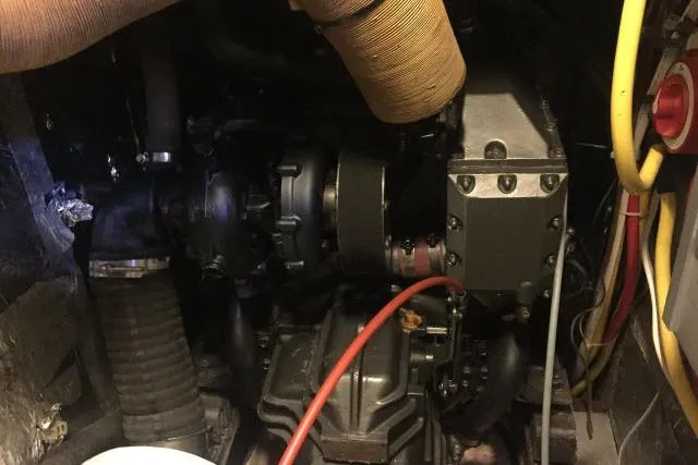 Slide: The Image of Engine compartment of a 1997 Gorbon Custom 66, featuring hoses and mechanical components. - 225