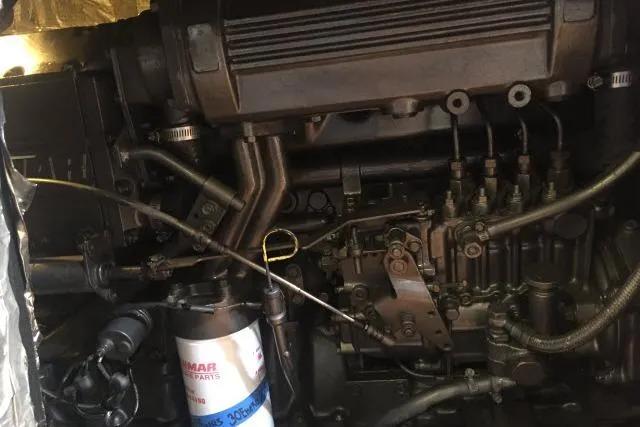 Slide: The Image of Engine compartment of a 1997 Gorbon Custom 66, showcasing mechanical components and Yanmar parts. - 227