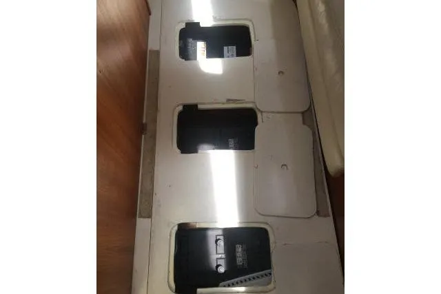 Slide: The Image of Battery compartments on a 1997 Gorbon Custom 66 yacht, featuring three visible storage units. - 228
