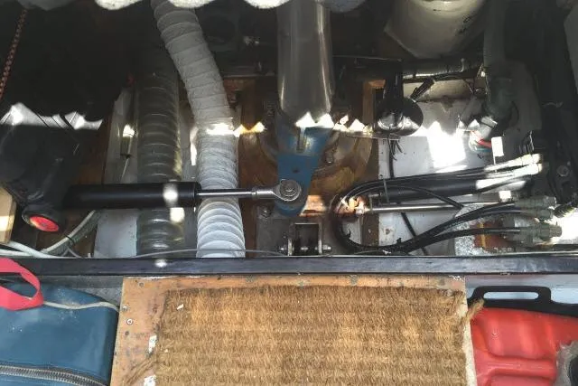 Slide: The Image of Engine compartment of a 1997 Gorbon Custom 66 boat, showing mechanical components and hoses. - 236