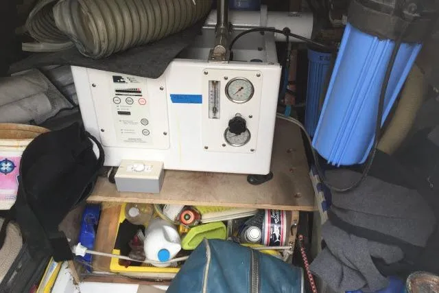 Slide: The Image of Industrial equipment setup in a cluttered space, featuring a 1997 Gorbon Custom 66 model. - 237