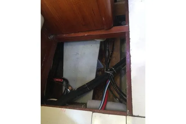 Slide: The Image of Underfloor compartment of 1997 Gorbon Custom 66 boat showing wiring and plumbing. - 238