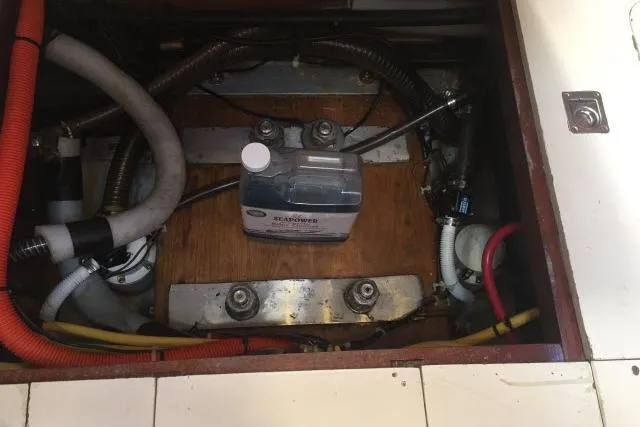 Slide: The Image of Engine compartment of a 1997 Gorbon Custom 66 with various hoses and a fluid container. - 239