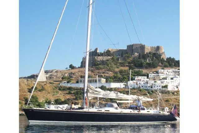 Slide: The Image of Sailing yacht Gorbon Custom 66, 1997, near a historic coastal fortress and white buildings. - 242