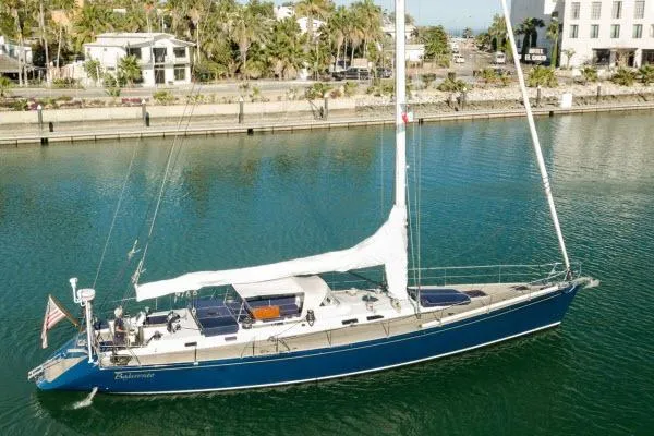 Slide: The Image of Sailing yacht Gorbon Custom 66, 1997 model, docked in a serene marina setting. - 246