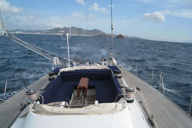 Slide: The Image of Sailing on a 1997 Gorbon Custom 66 yacht, open sea view with distant mountains. - 247