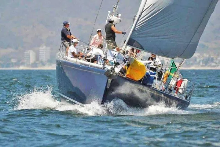 Slide: The Image of Sailing yacht Gorbon Custom 66, 1997 model, navigating ocean waves with crew onboard. - 252