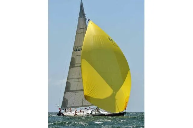 Slide: The Image of Sailing yacht Gorbon Custom 66 (1997) with a large yellow spinnaker on open water. - 253