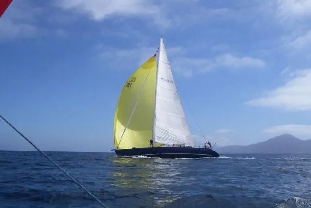 Slide: The Image of Sailing yacht Gorbon Custom 66 (1997) with yellow and white sails on open sea. - 254