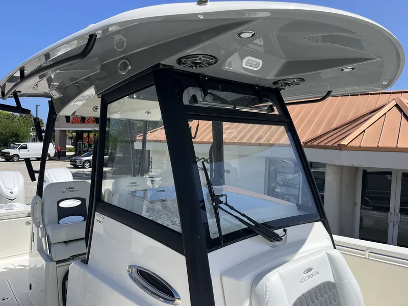 Slide: The Image of 2026 Cobia 320 Center Console boat cockpit view. - 26