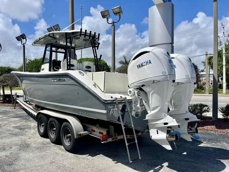 Slide: The Image of 2026 Cobia 320 Center Console boat with Yamaha engines on trailer. - 4