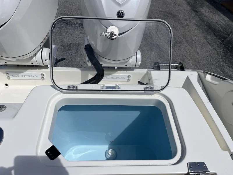 Slide: The Image of Cobia 320 Center Console 2026 with open storage compartment. - 29