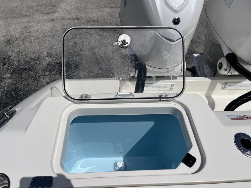 Slide: The Image of 2026 Cobia 320 Center Console with open storage compartment. - 30